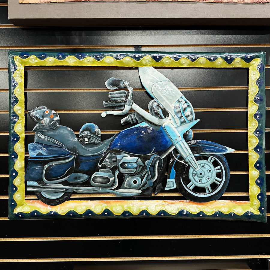 Metal wall art with motorcycle image in greens blues and cream